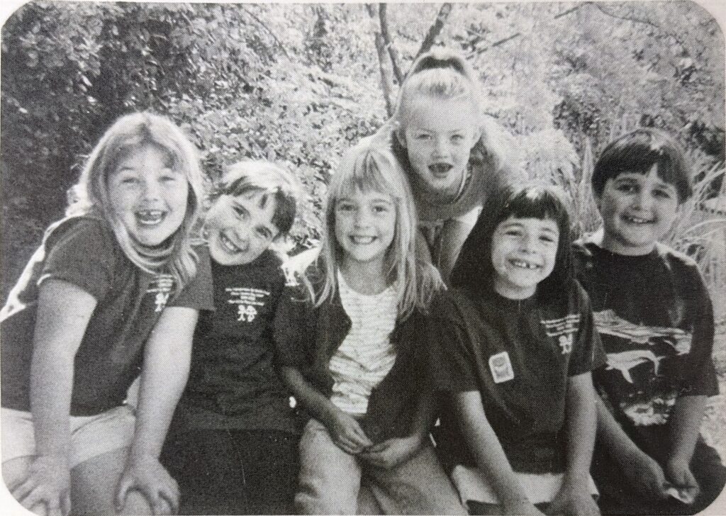 A group of six smiling students from CCDS early years
