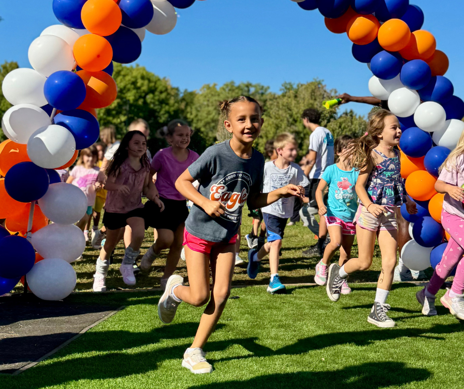 Student joyfully running with classmates on Jog-a-Thon day