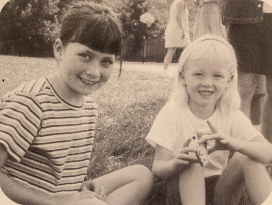 two students smiling on the CCDS field